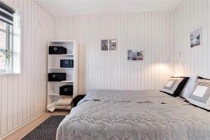 a bedroom with a bed and a book shelf at 0430-Romo-Vestergade-3-Ap-71 in Høm