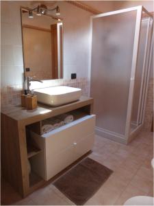 a bathroom with a sink and a shower at Abri Douillet in Saint Marcel