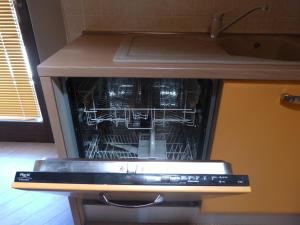 an oven with its door open with its dishes inside at Abri Douillet in Saint Marcel