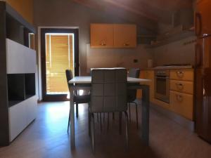 a kitchen with a table and chairs and a window at Abri Douillet in Saint Marcel
