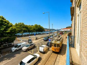 a street filled with cars parked next to a building at Ribeira Porto by MyStay - Self Check-in Hotel in Porto
