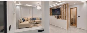 a living room with a couch and a television at Les 3 perles in Ras El Ma