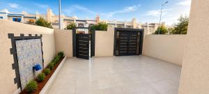 a courtyard with two doors in a building at Les 3 perles in Ras El Ma