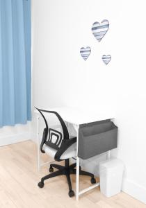 a desk with a chair and hearts on a wall at Beachh - 2Beach Home - Blue3090 in Brooklyn