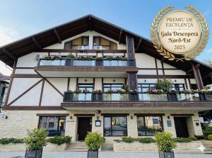 a building with a sign on the front of it at KABAN BOUTIQUE HOTEL - 5Star Central Villa in Vatra Dornei in Vatra Dornei