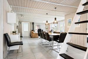 a dining room and living room with a table and chairs at 0203-Romo-Peder-Jespersensvej-4 in Høm