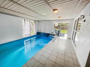 a swimming pool with blue water in a house at 0203-Romo-Peder-Jespersensvej-4 in Høm