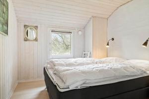 a bedroom with a large bed in a room with a window at 0203-Romo-Peder-Jespersensvej-4 in Høm +24 photos