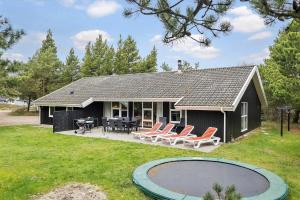 a house with chairs and a patio and a pool at 0203-Romo-Peder-Jespersensvej-4 in Høm