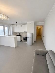 a living room with a couch and a kitchen at White Residency in Yerevan +7 photos