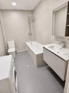a bathroom with a tub and a sink and a toilet at White Residency in Yerevan