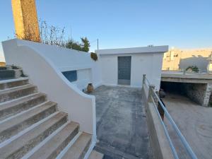 a stairway leading up to a white building at Olive Mill Complex in Livadi