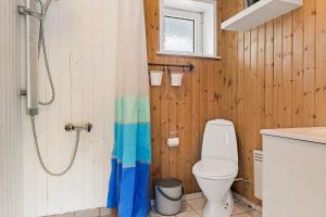 a bathroom with a toilet and a shower curtain at 0416-Romo-Dyssebjergvej-13 in Høm +32 photos
