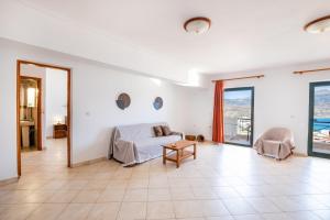 a large living room with a bed and a table at Fronis Studios in Karpathos