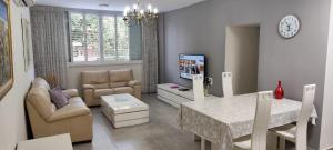 a living room with a table and a dining room at Herzliya Center Apartments in Herzliya