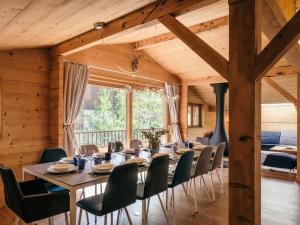 a dining room with a long table and chairs at Chalet 4★, 15 pers, La Clusaz, sauna, centre village, 7 chambres - FR-1-304-177 in La Clusaz