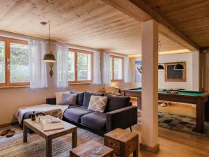 a living room with a couch and a pool table at Chalet 4★, 15 pers, La Clusaz, sauna, centre village, 7 chambres - FR-1-304-177 in La Clusaz