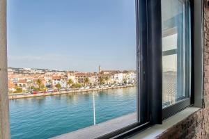 a view of a river from a window at Le Venise Factory in Martigues