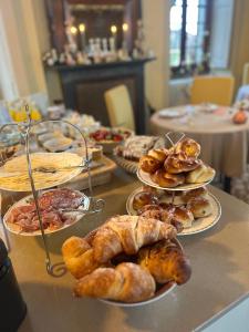 a table with many different types of pastries on plates at Villa il Maiale Bianco Bed & Breakfast in San Fedele Intelvi