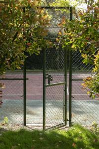 a tennis court with a chain link fence at The Olde Bell, BW Signature Collection in Marlow