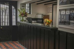 a lobby with a counter with a bowl of fruit on it at The Olde Bell, BW Signature Collection in Marlow
