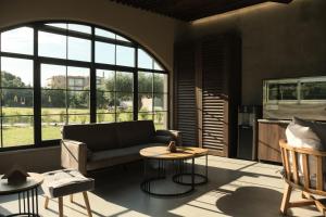 a living room with a couch and a table at Royal Hotel and Suites in Polychrono