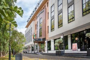 an empty street in front of a building at Hotel San Pablo Sevilla in Seville