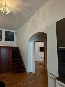 a living room with a staircase and a room with a ceiling at Ultra Central Cluj-Napoca in Cluj-Napoca