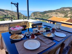 a blue table with food on top of a balcony at Qekik Boutique Kazdağları in Arıklı