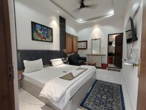 a bedroom with a large bed and a living room at Khushi Paying Guest House in Varanasi