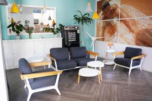 a room with couches and chairs and tables at Coral Compostela Beach Golf in Playa de las Americas