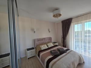 a bedroom with a bed and a large window at Nemunas Riverside in Kaunas