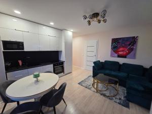 a living room with a couch and a table at Nemunas Riverside in Kaunas