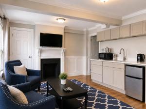 a kitchen and living room with a couch and a table at Bellevue House in Newport