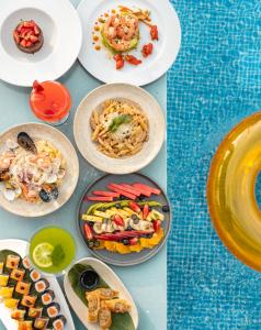 a bunch of plates of food on a table at Mandarin Hotel & Spa Tanger in Tangier