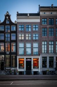 a large brick building on a city street at Hotel Mansion in Amsterdam