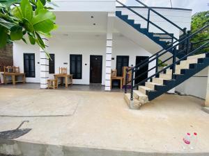 a building with a staircase and a stair case at NRT Beach Hotel in Trincomalee +2 photos