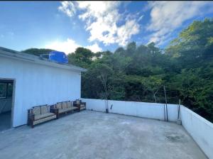 a balcony with two benches on top of a building at NRT Beach Hotel in Trincomalee