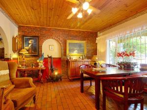 a living room with a table and a couch at Raptor's Rest Bed and Breakfast in Empangeni