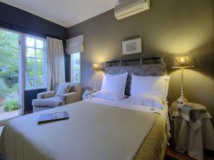 a bedroom with a large bed with a book on it at Raptor's Rest Bed and Breakfast in Empangeni