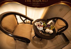 a chair in a hotel room with products on it at The Milford Noida in Noida