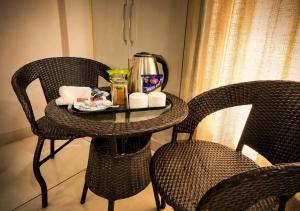 a table with a coffee maker on top of it at The Milford Noida in Noida +19 photos