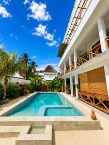 a swimming pool in the courtyard of a house at Olacoco by Olamanga in Jambiani