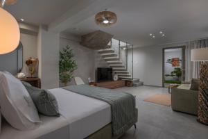 a bedroom with a large bed and a staircase at Kassandra Villas in Hanioti +106 photos