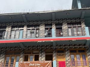 a man standing on a balcony of a building at Rock View in Kulu