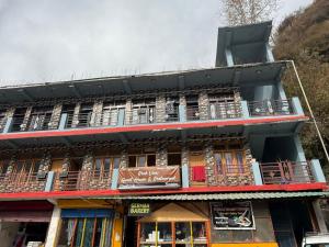 a building with balconies on the side of it at Rock View in Kulu