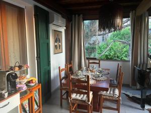 a dining room with a table and chairs and a window at B&B Il Castello di Alberico in Cotignola