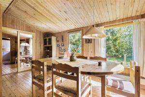 a kitchen with a table and chairs in a room at 13318-Asnaes-Lindevej-10 in Asnæs