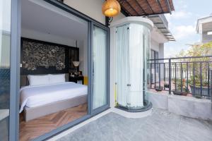 a bedroom with a bed on a balcony at Brilliant Jade Suites in Hanoi