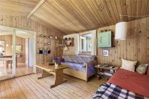 a bedroom with a couch and a table in a room at 13318-Asnaes-Lindevej-10 in Asnæs +12 photos